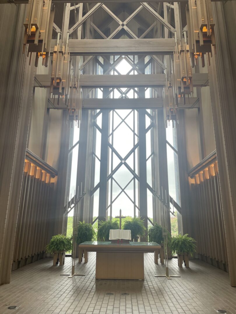 Modern chapel interior with tall windows.