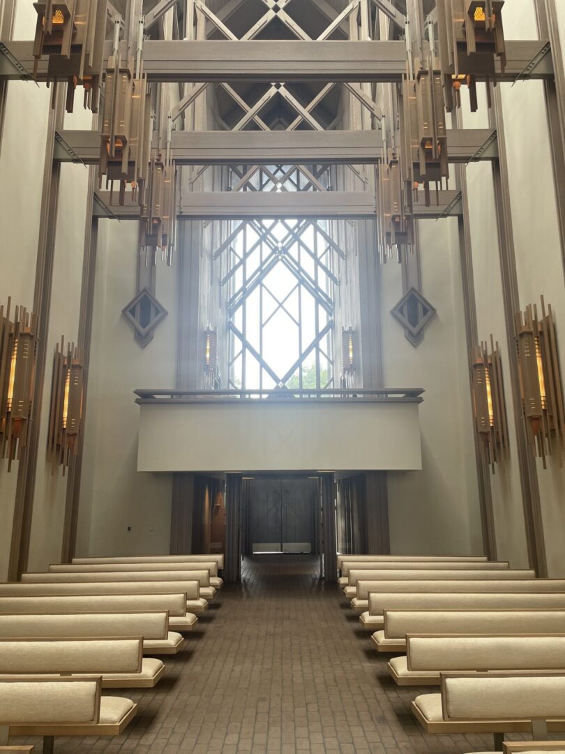 Modern chapel interior with wooden pews.