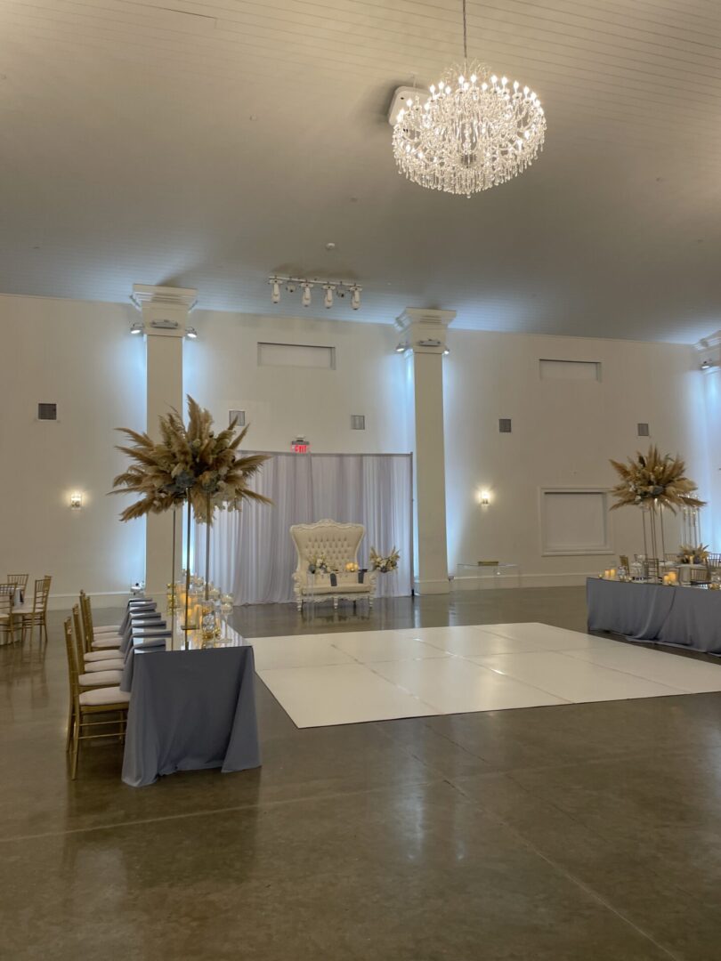 Elegant banquet hall with chandelier and decorations.