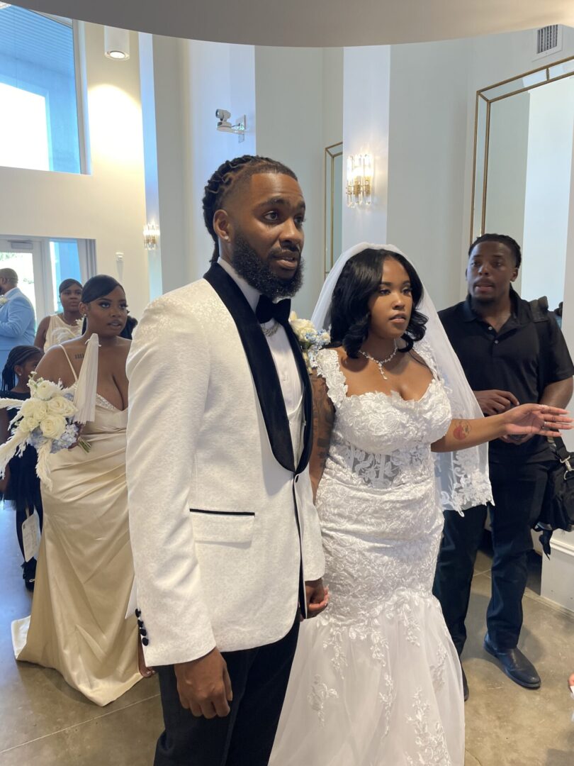 Bride and groom standing with guests.