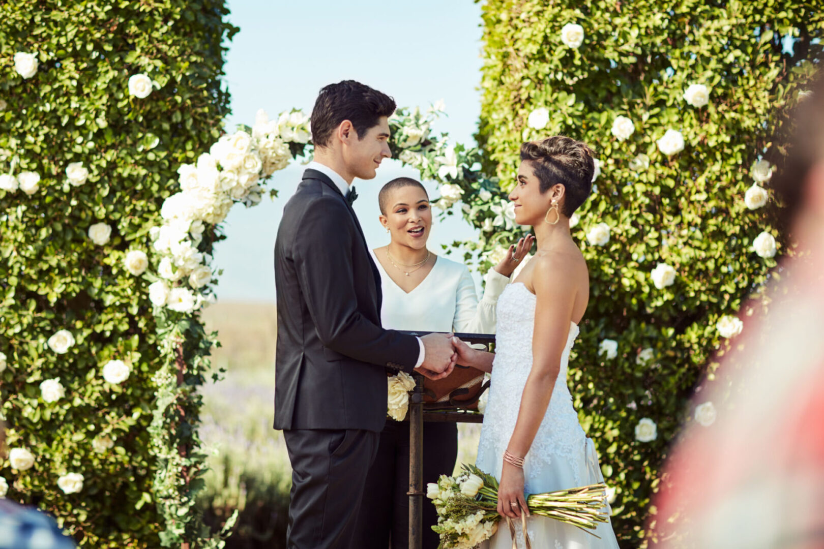 Bride and groom exchanging vows outdoors.
