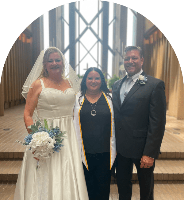 Bride, groom, and officiant in wedding ceremony.